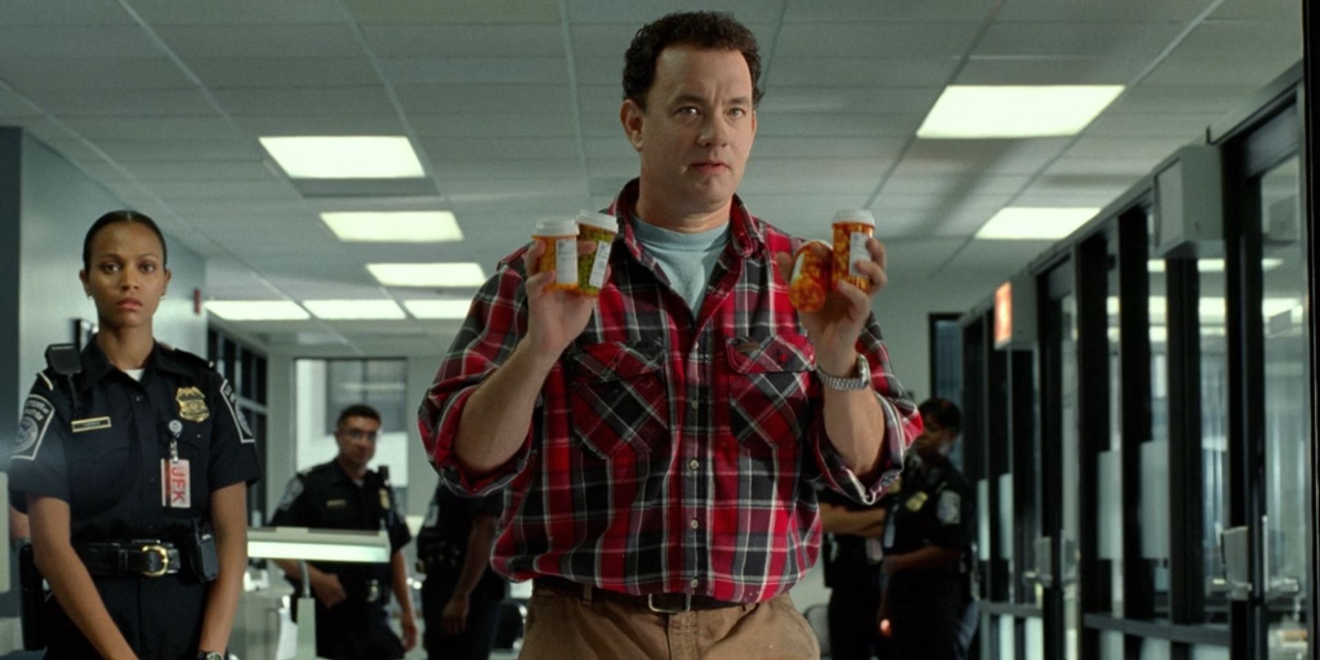 Viktor Navorski, played by Tom Hanks, holds bottles filled with pills in 'The Terminal'.