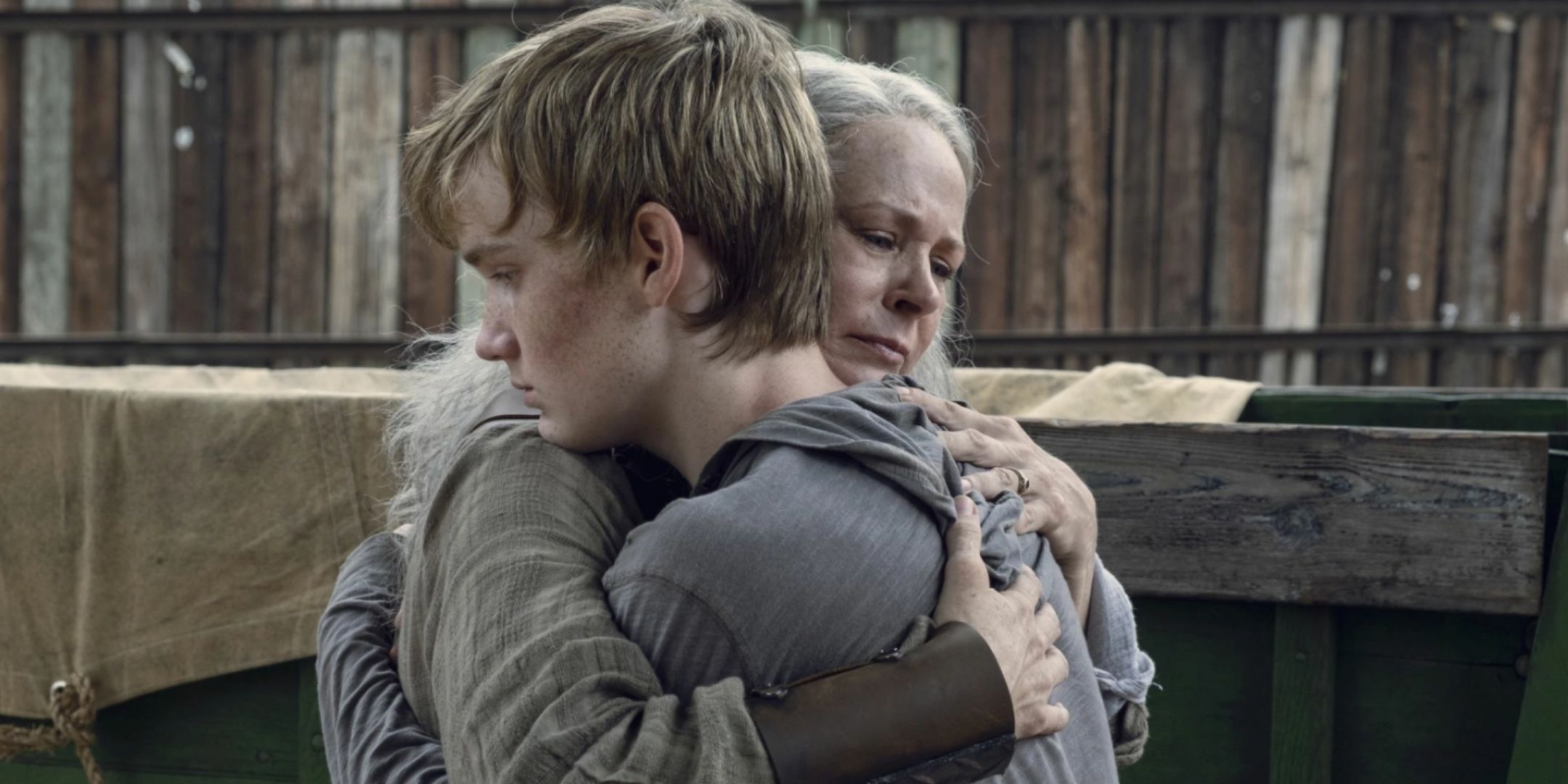 Melissa McBride as Carol hugging Matt Lintz as Henry in The Walking Dead