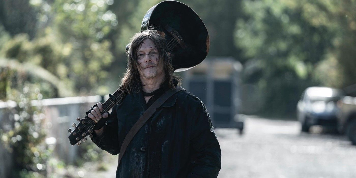 Daryl (Norman Reedus) holding a guitar in 'The Walking Dead: Daryl Dixon'