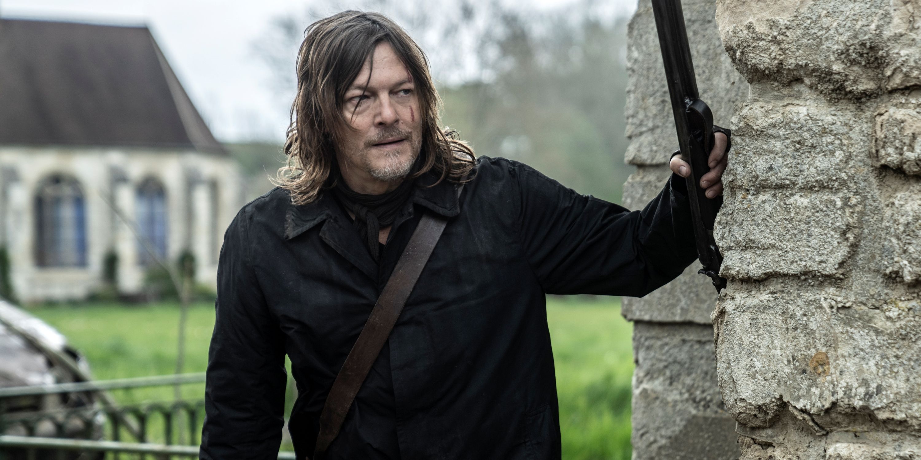 Norman Reedus as Daryl holding a rifle against a wall in The Walking Dead: Daryl Dixon Season 2