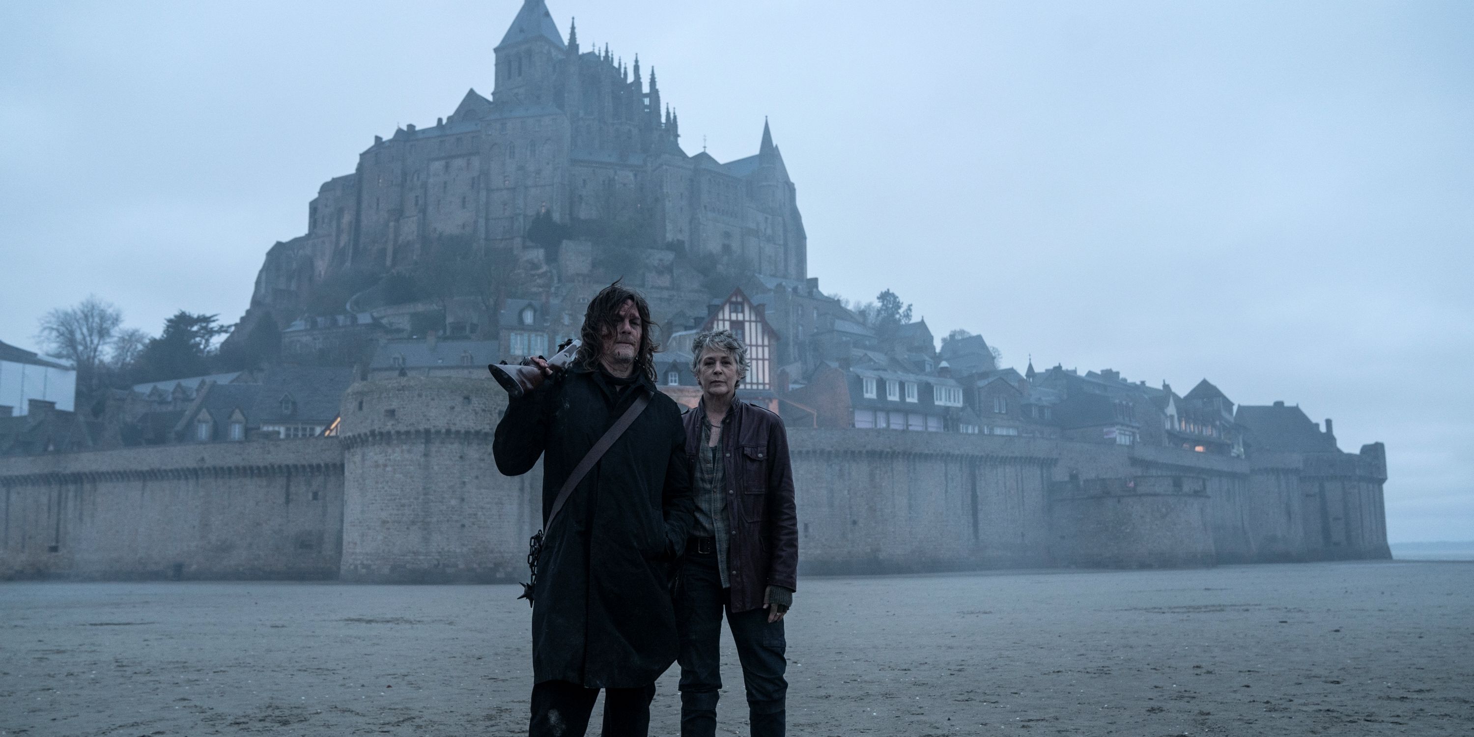 Norman Reedus as Daryl and Melissa McBride as Carol standing together in The Walking Dead: Daryl Dixon