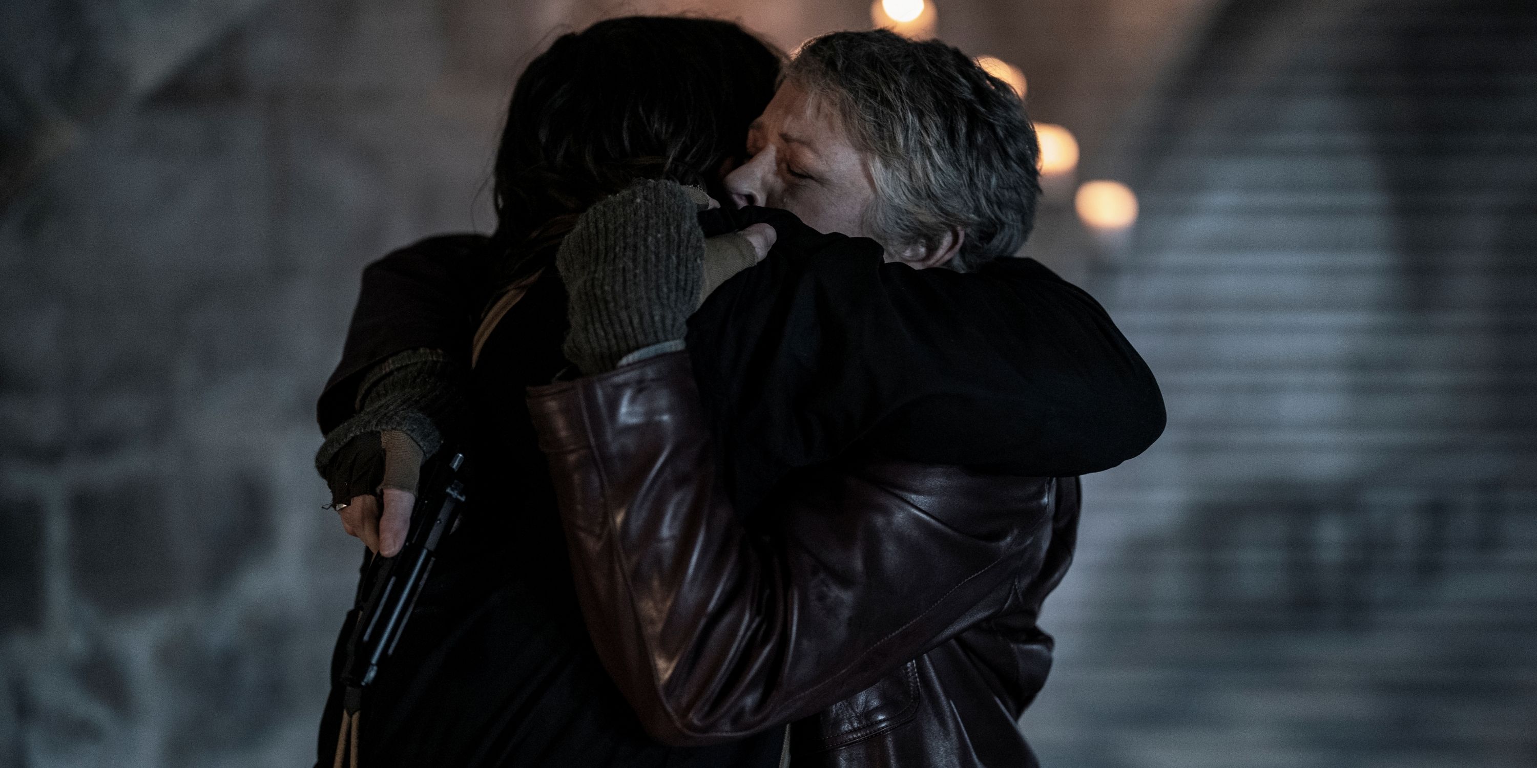 Norman Reedus as Daryl and Melissa McBride as Carol hugging tightly in The Walking Dead: Daryl Dixon