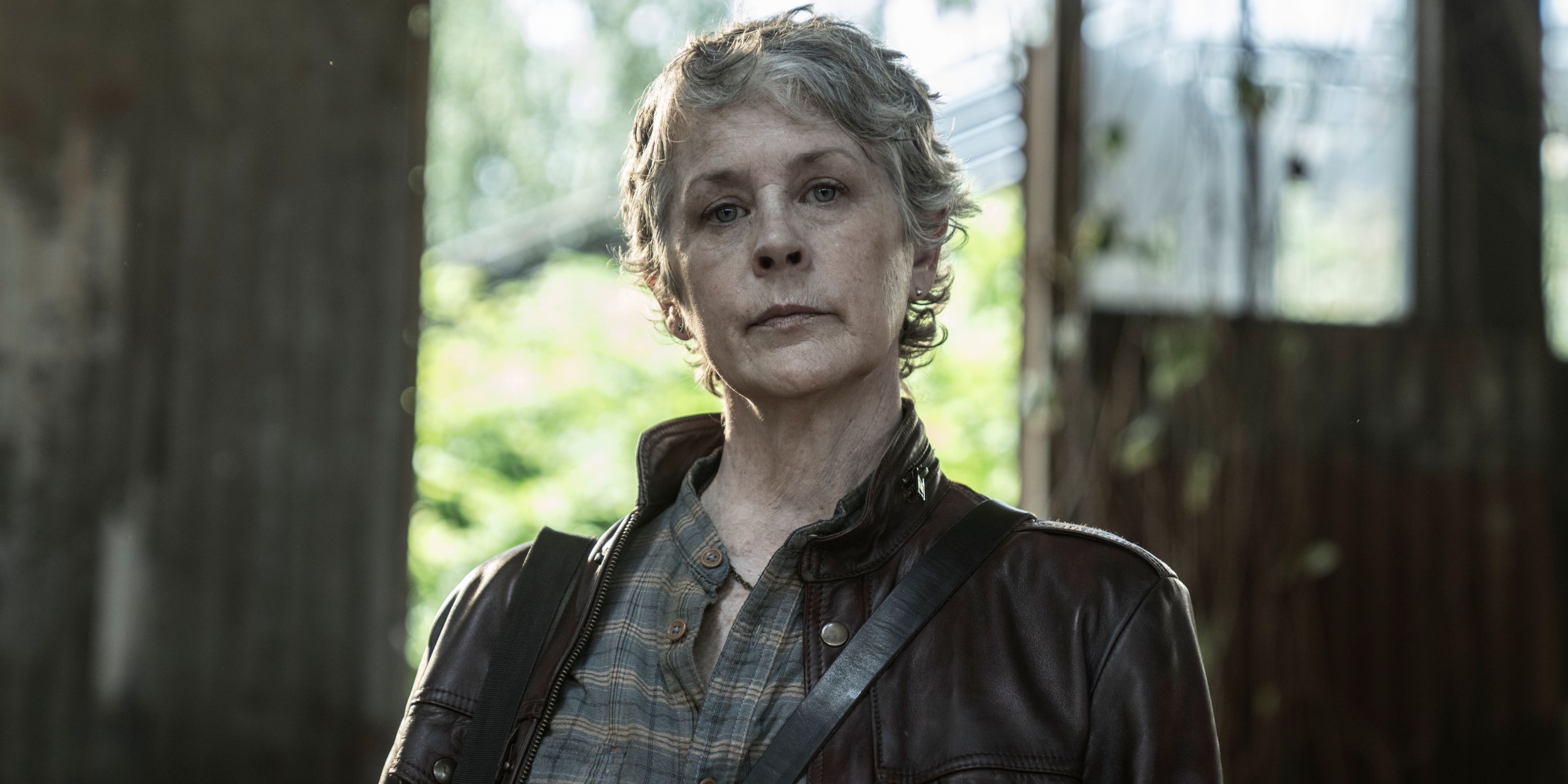 Melissa McBride as Carol looking into the camera and smirking in The Walking Dead: Daryl Dixon Season 2