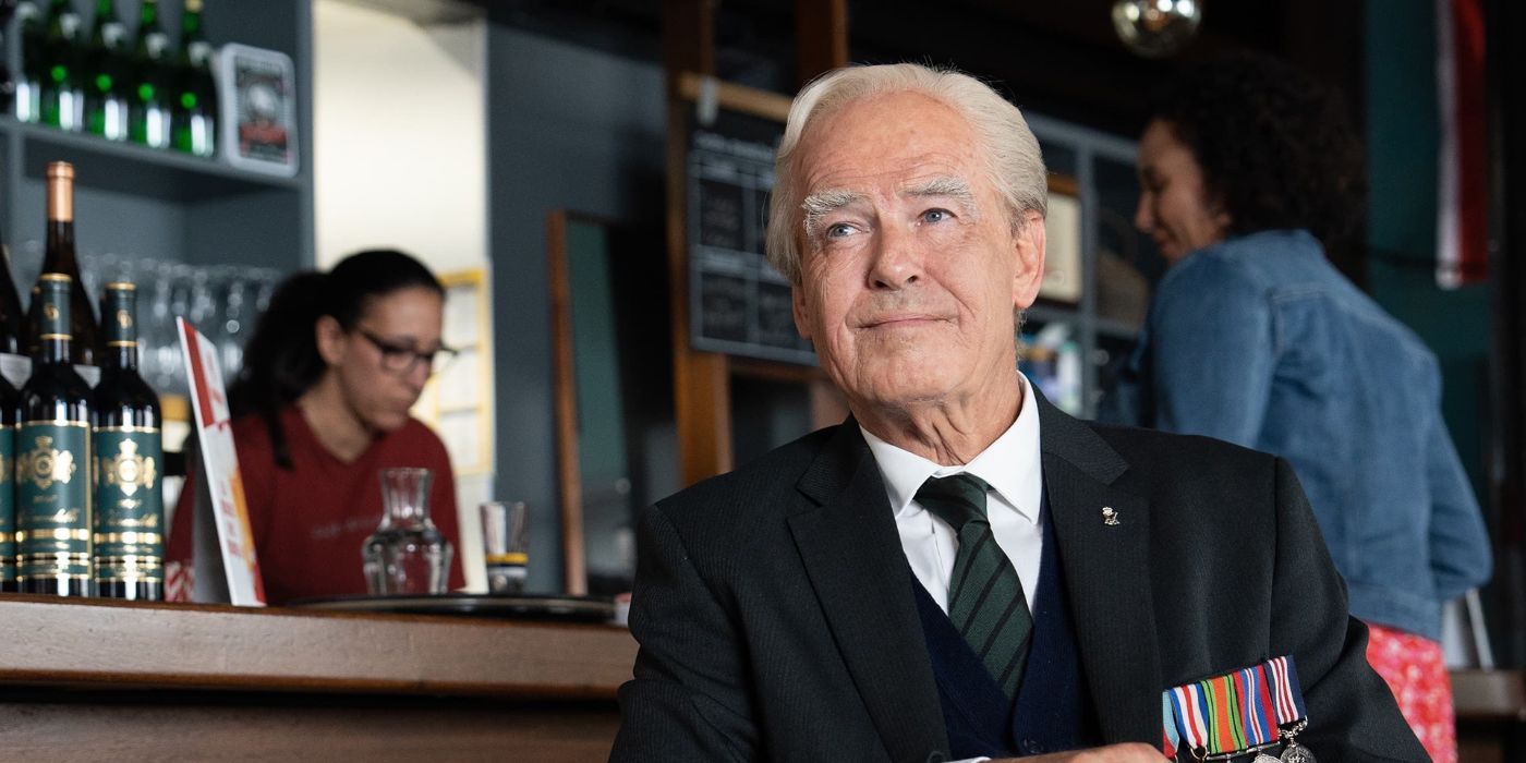 Pierce Brosnan as Artie - a WWII vet - in 'The Last Rifleman' sits at a bar wearing his medals of honor