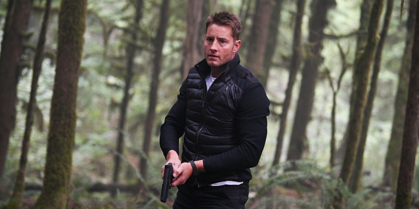 Justin Hartley brandishing a gun in the woods