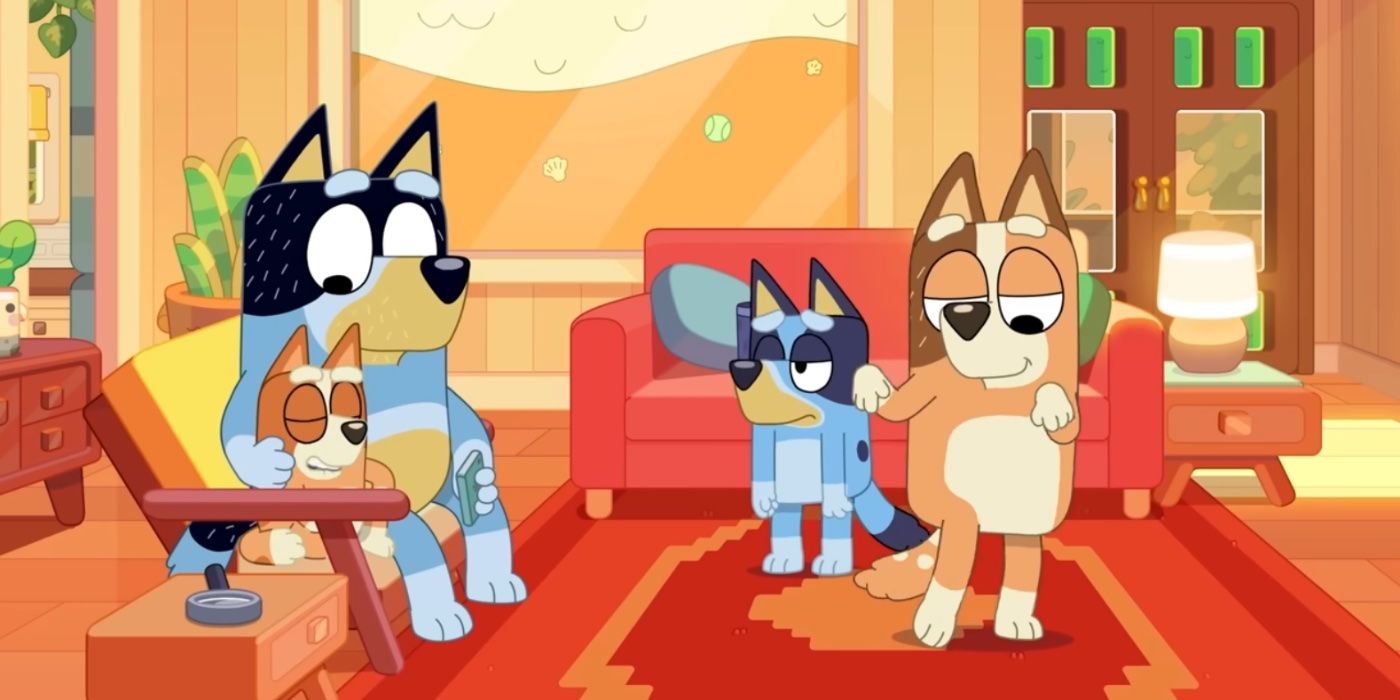 Bingo and Bandit sit on the couch while Bluey stares begrudgingly and Chilli dances on her own.