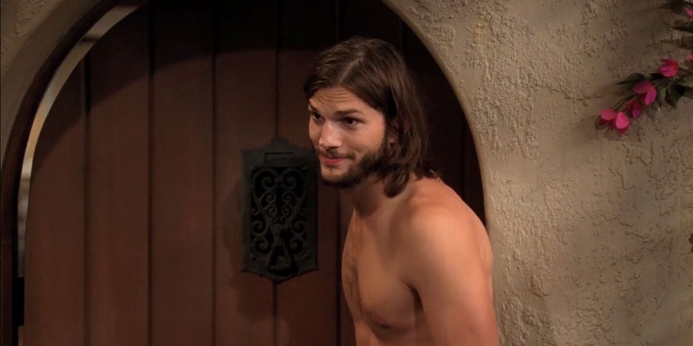 Walden standing at the front door smiling without a shirt on in Two and a Half Men