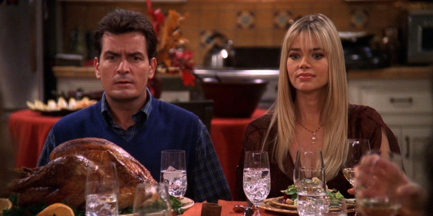 Charlie and Lisa sitting at the kitchen table looking alarmed in an episode of Two and a  Half Men.