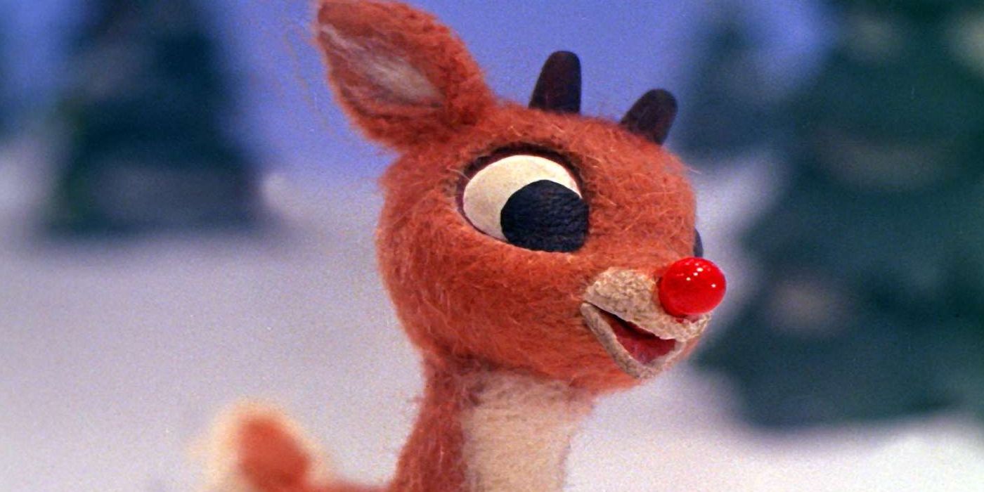 Up close image of Rudolph the red-nosed reindeer smiling.