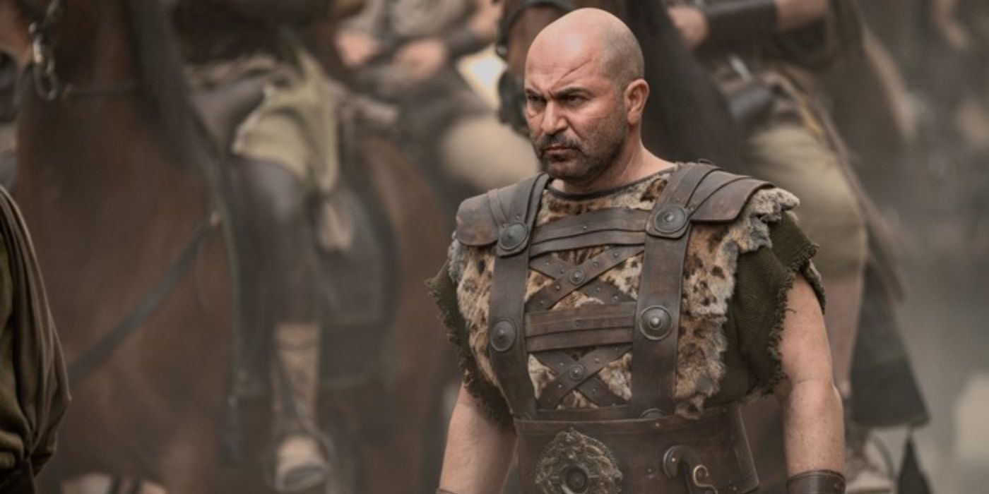 A still of Viggo (Lior Raz) standing in a crowded place and looking menacing in a scene from &lsquo;Gladiator II&rsquo;