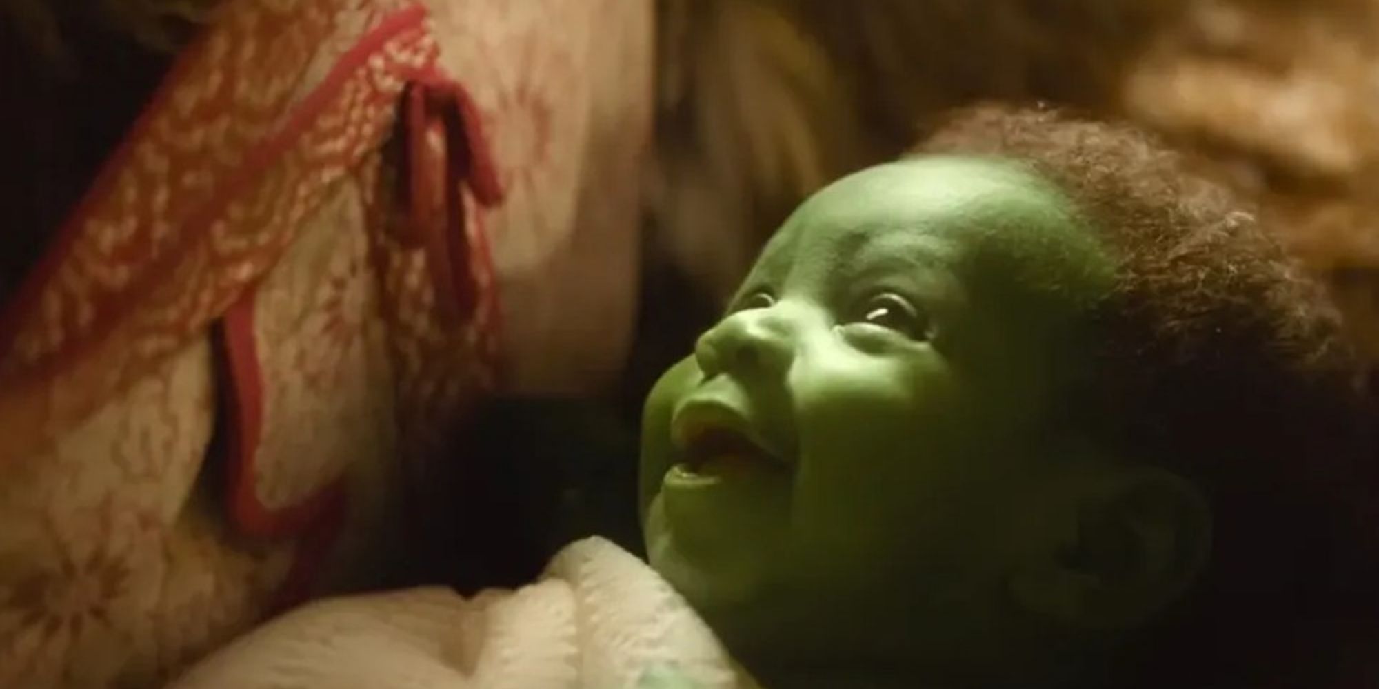 Baby Elphaba smiling in Wicked.