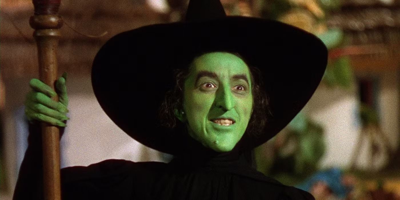 Margaret Hamilton as The Wicked Witch of the West holding her staff in 'The Wizard of Oz'