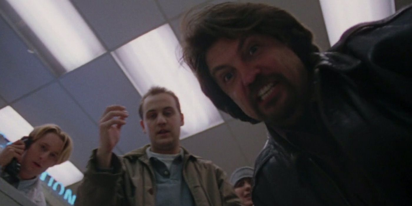Tom Savini leans over a man in Wishmaster