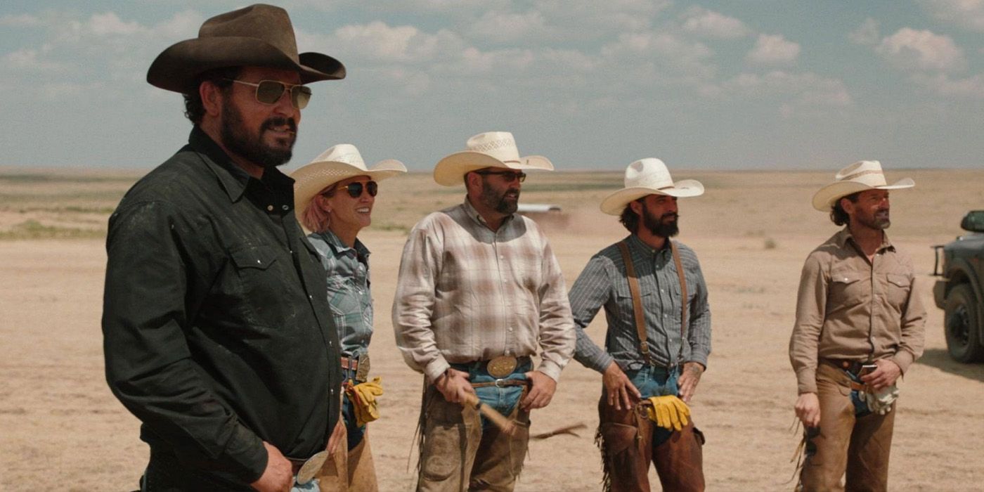 Rip Wheeler (Cole Hauser), Teeter (Jen Landon), Jake (Jake Ream), Walker (Ryan Bingham), and Ryan (Ian Bohen) stand around on the Four Sixes (6666) Ranch in Texas on Yellowstone.