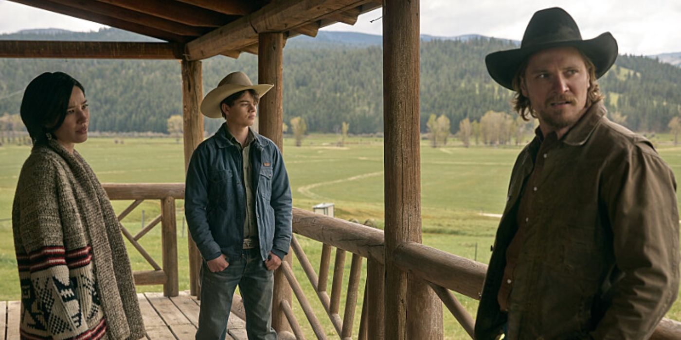 Kayce (Luke Grimes), Monica (Kelsey Asbille), and Tate (Brecken Merrill) on a porch in Yellowstone.