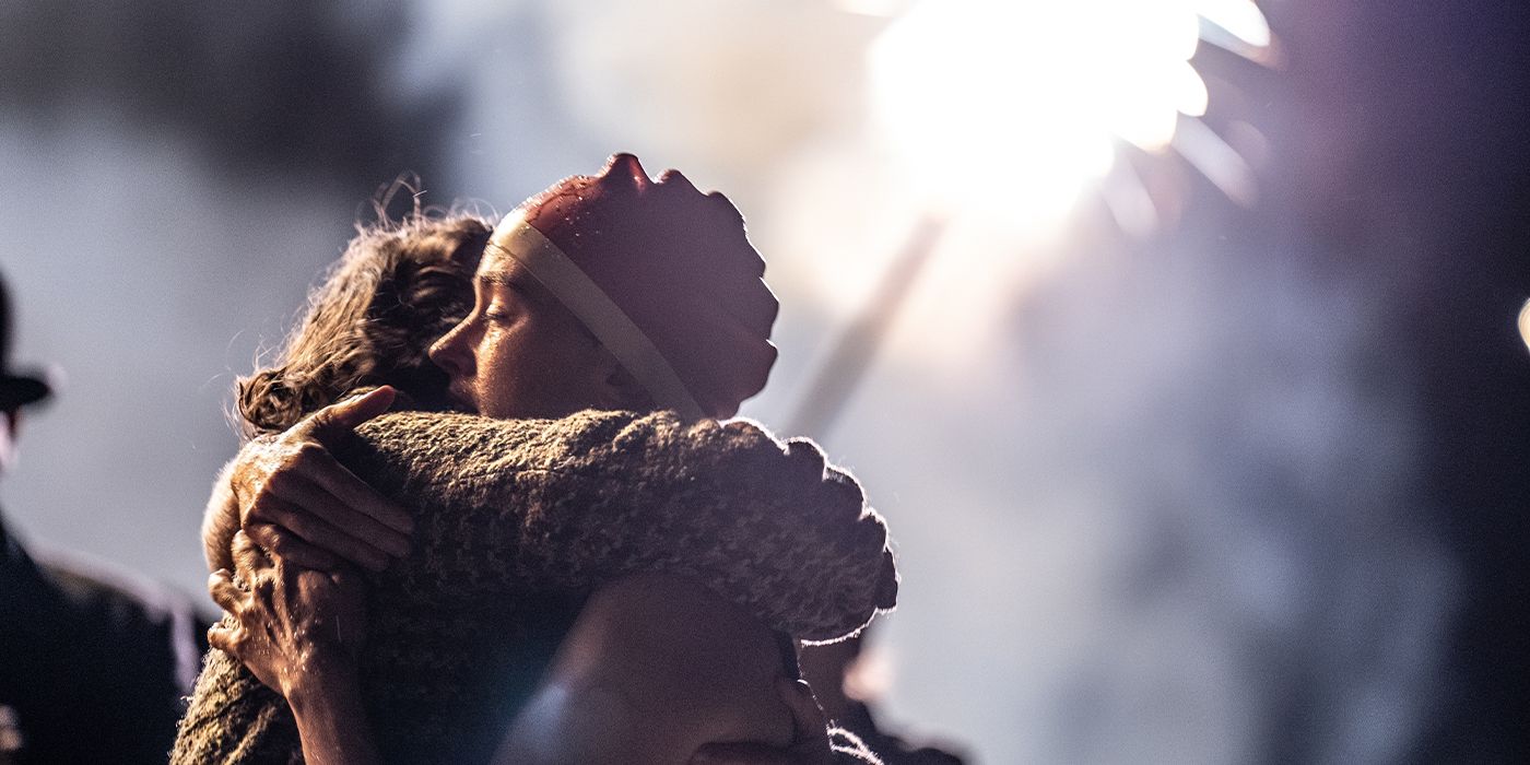 Trudy Ederle (Daisy Ridley) hugging a woman under fireworks at night
