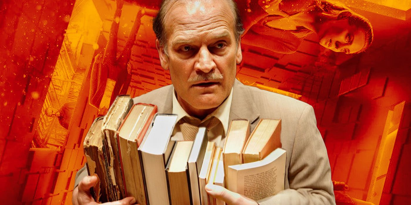 Hilbert, played by actor Lluís Homar, carries a handful of books against an upside-down room.