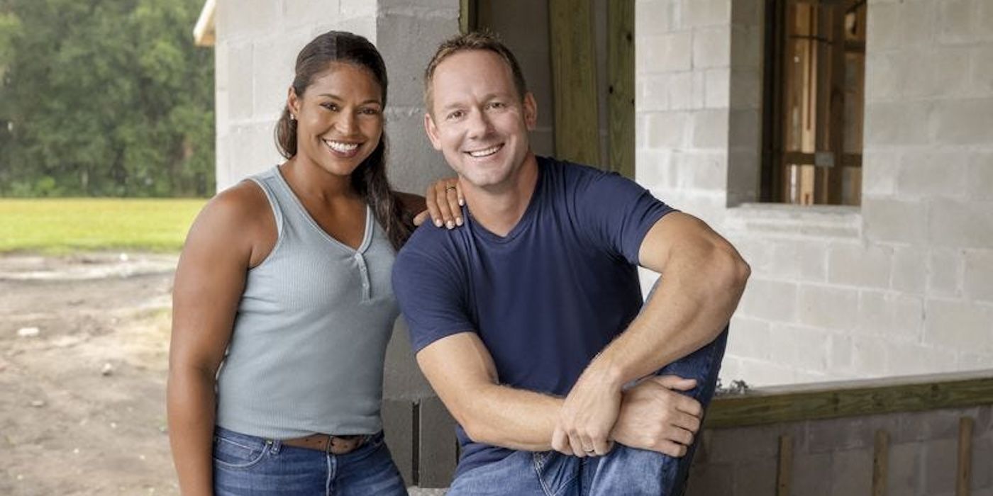 Brian and Mika Kleinschmidt smile in front of a house under construction in 100 Day Dream Home.