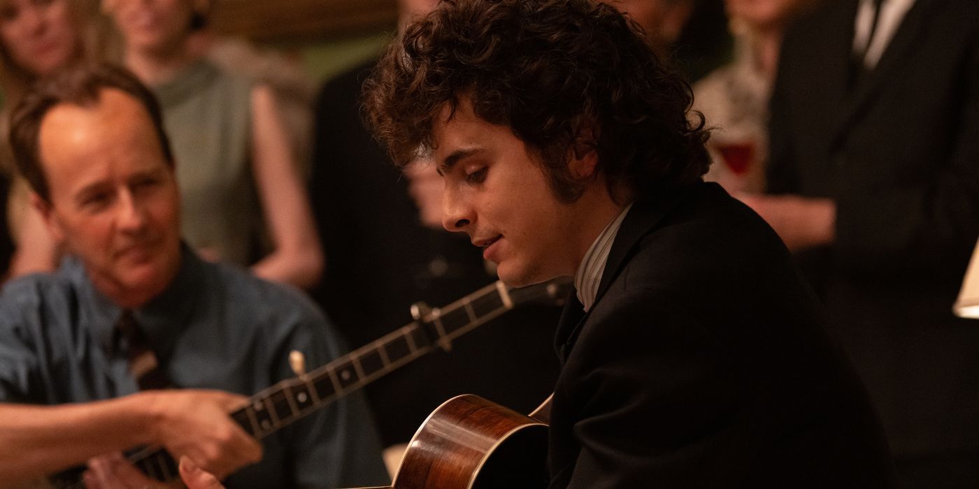 Edward Norton's Pete Seeger watching Timothee Chalamet's Bob Dylan play his guitar in A Complete Unknown.