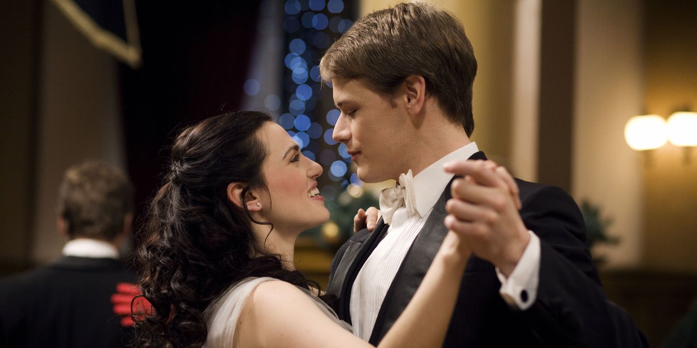 Ashton (Sam Heughan) wearing a tuxedo and holding Jules (Katie McGrath) in a waltz pose in Hallmark's A Princess for Christmas