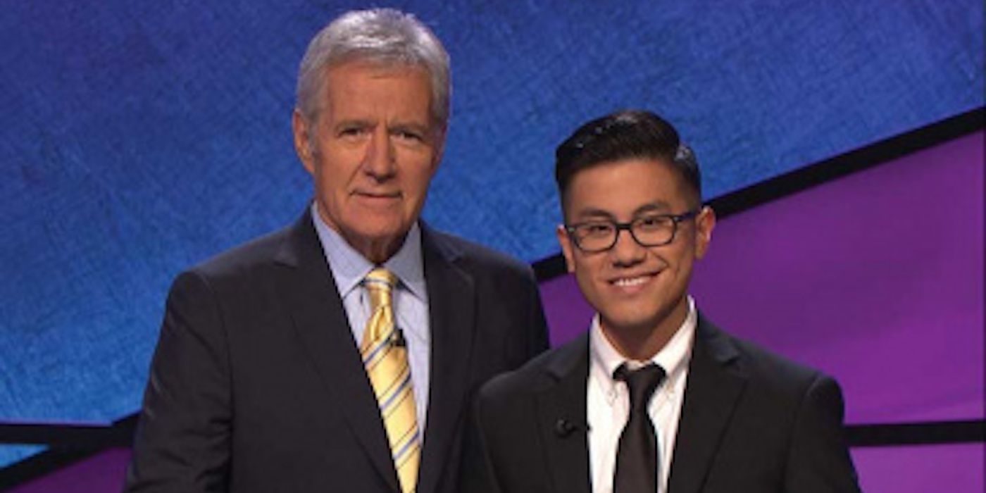 Alex Trebek standing beside Dan Tran in 'Jeopardy'