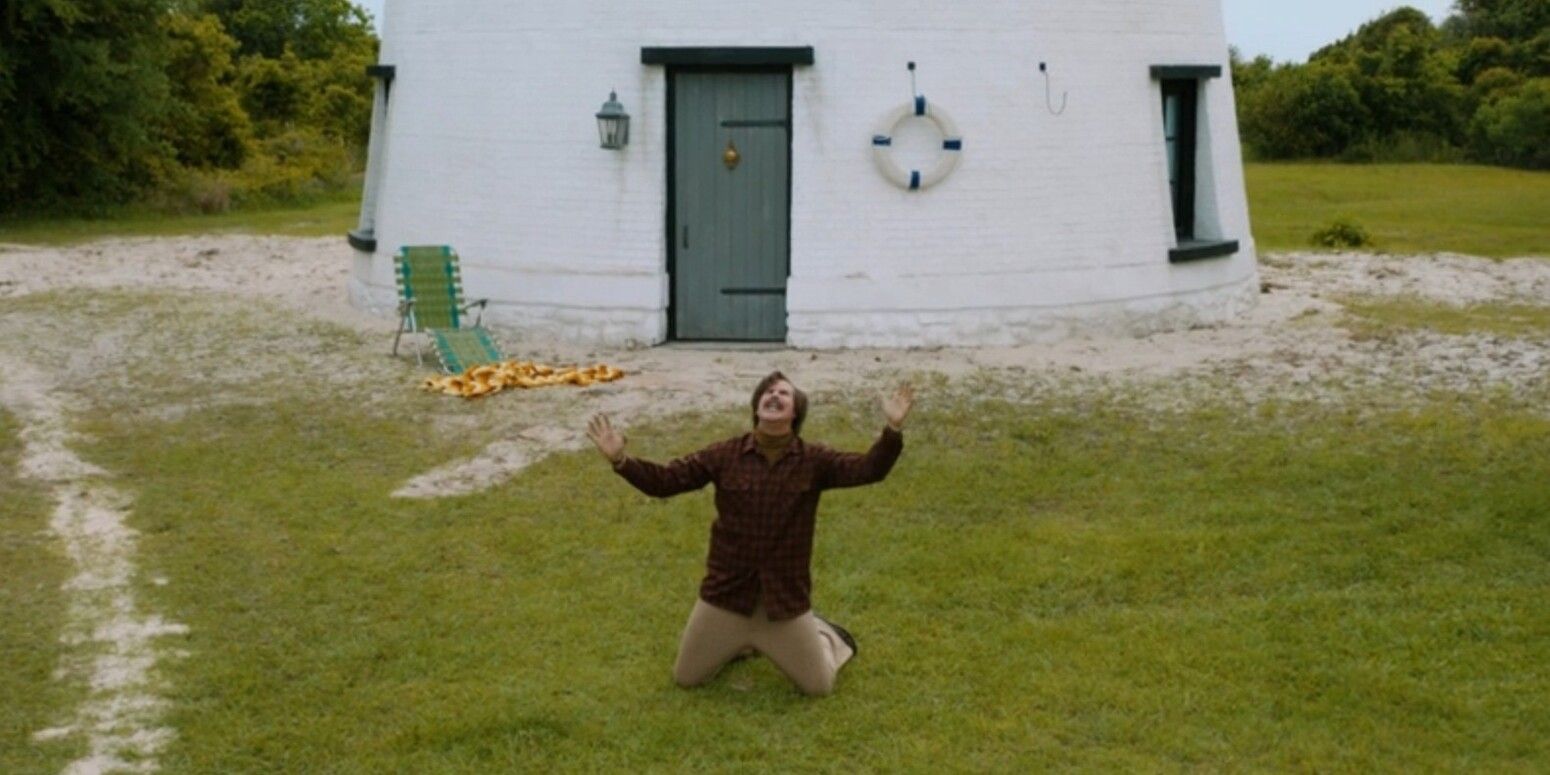 Will Ferrell as Ron Burgundy on his knees and screaming while in front of a lighthouse in Anchorman 2: The Legend Continues