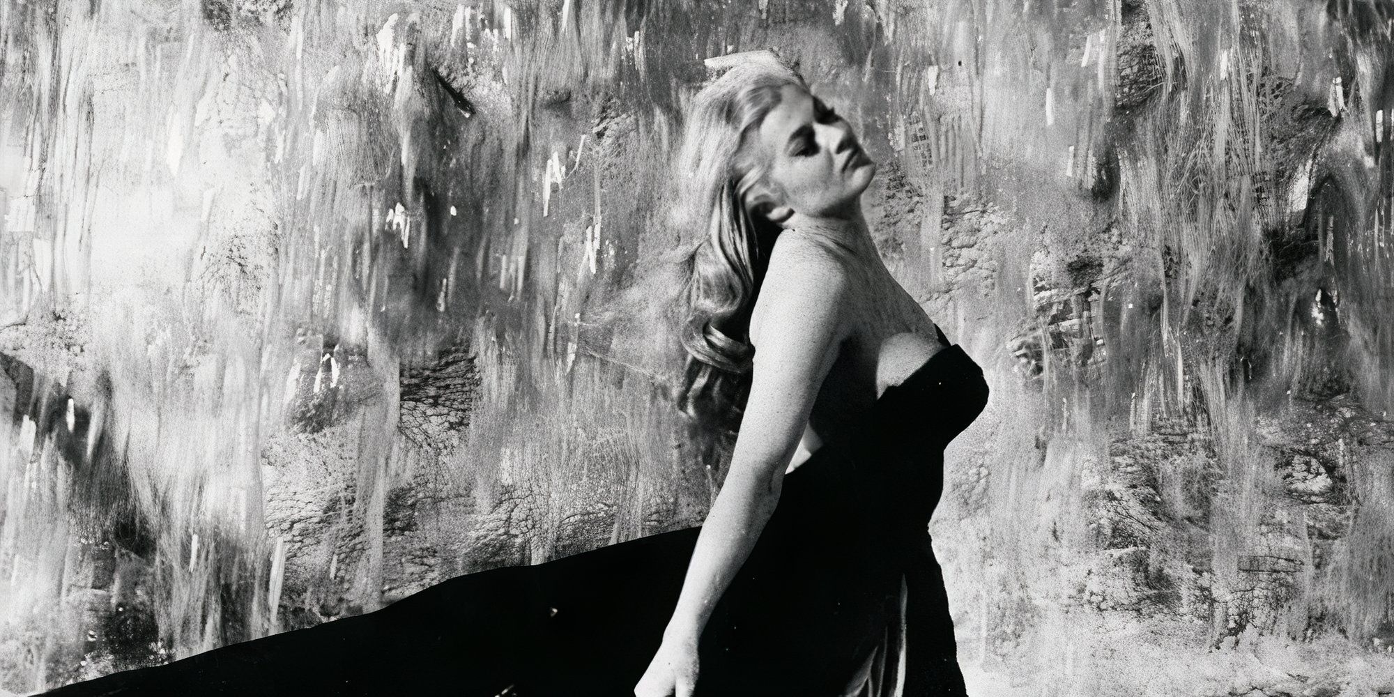 Anita Ekberg as Sylvia in La Dolce Vita wearing a long black dress.