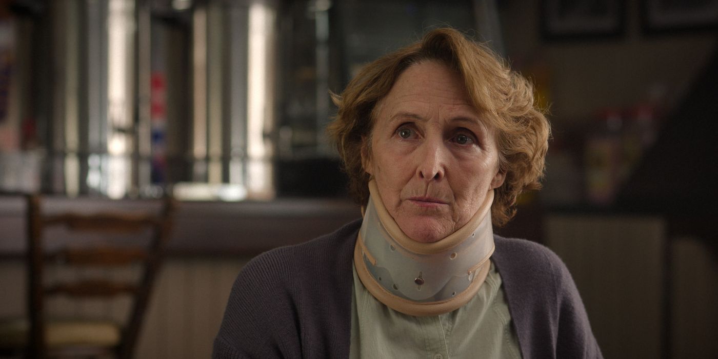 Fiona Shaw (Angelica) wearing a neck brace