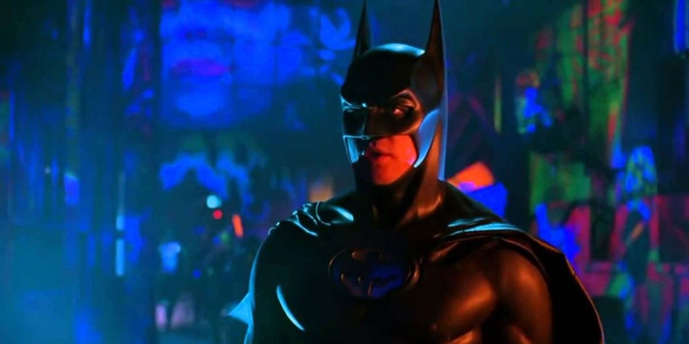 Val Kilmer as Batman staring ahead with a vivid color setting behind in 'Batman Forever'.