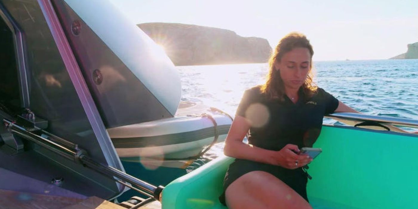 Emma Crouch on her phone on deck on 'Below Deck Sailing Yacht.'