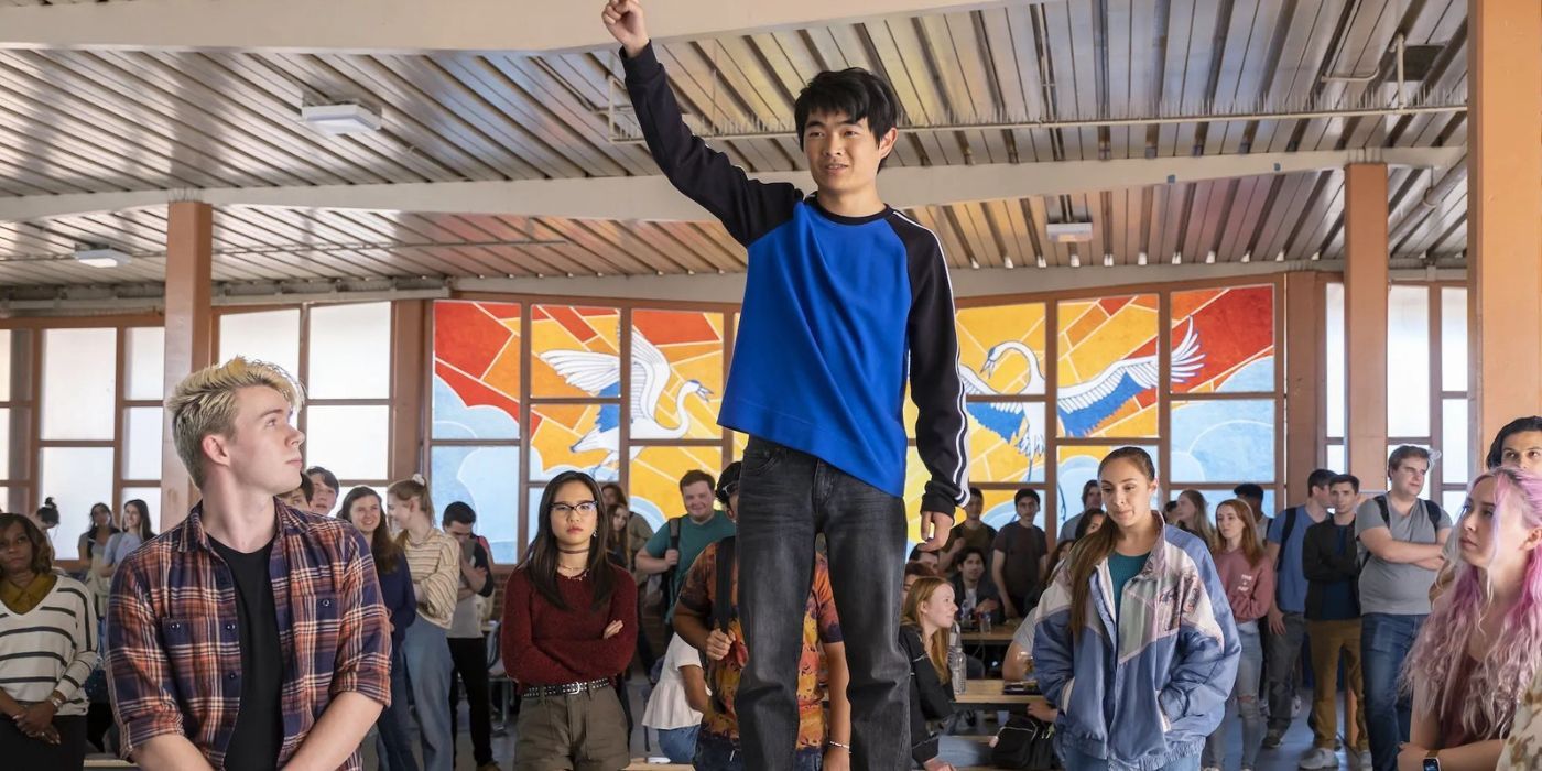 Ben Wang standing on a lunch table in American Born Chinese.