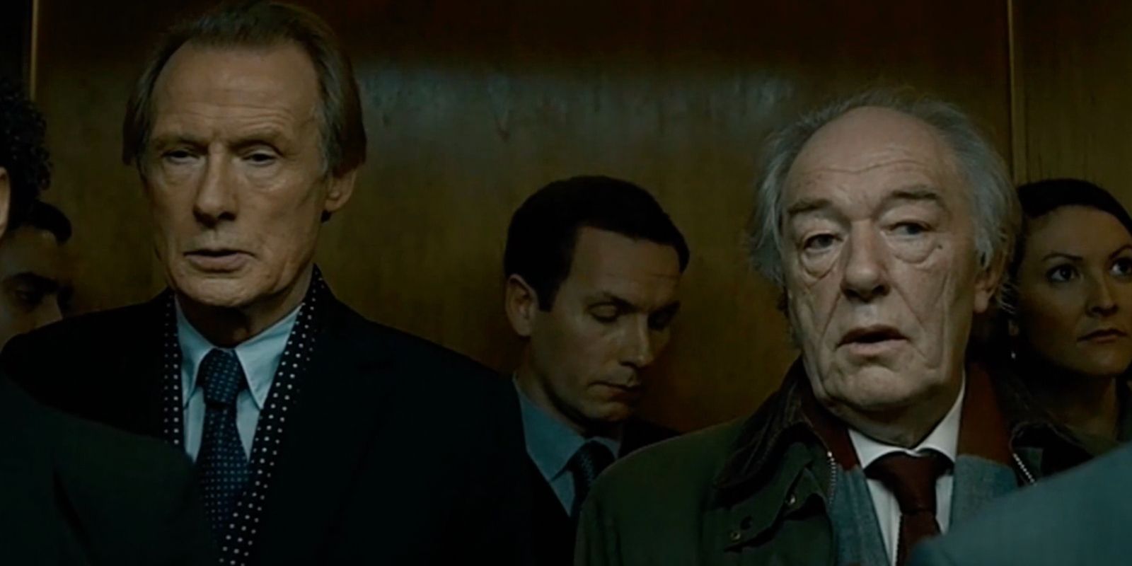 Bill Nighy as Johnny and Michael Gambon as Benedict chatting in an elevator in Page Eight.