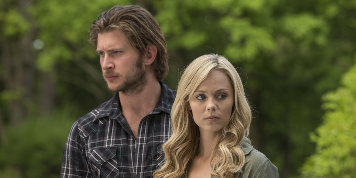 Elena and Clayton standing outside and staring off-screen in opposite directions in the series Bitten.