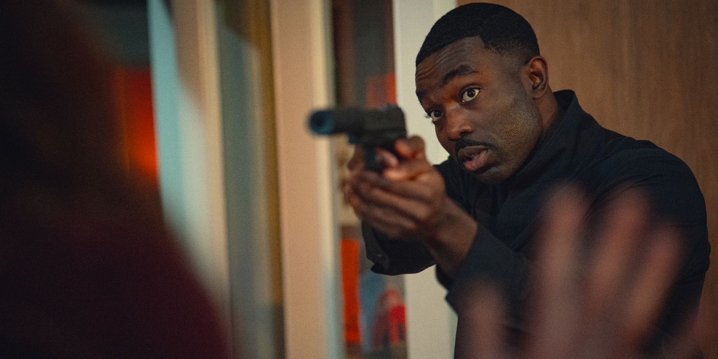 Paapa Essiedu pointing a gun at Keira Knightley in Black Doves