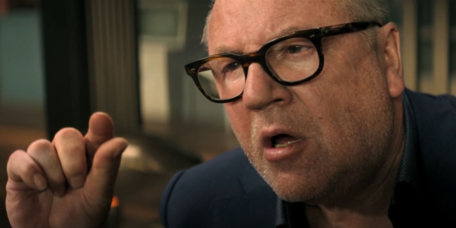 Dreykov, played by Ray Winstone, holds two fingers close together in 'Black Widow'.