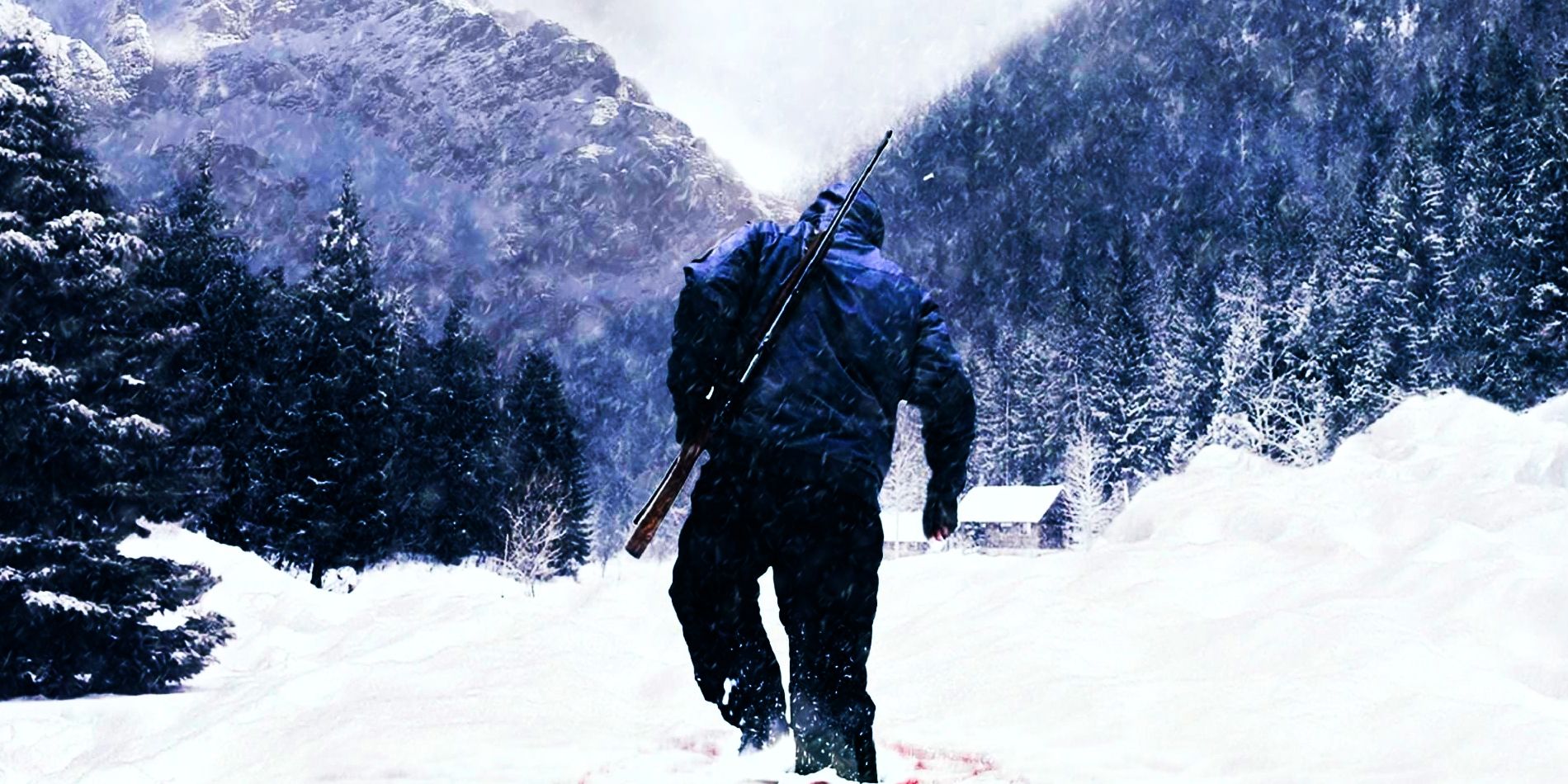 A darkly-dressed human figure trudges through the snow towards a cabin with a rifle over their shoulder.