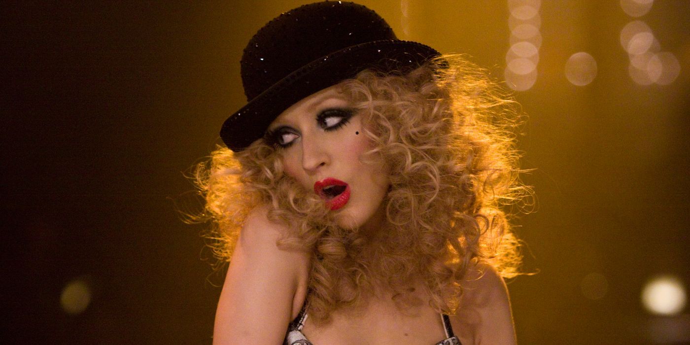 Ali singing in Burlesque