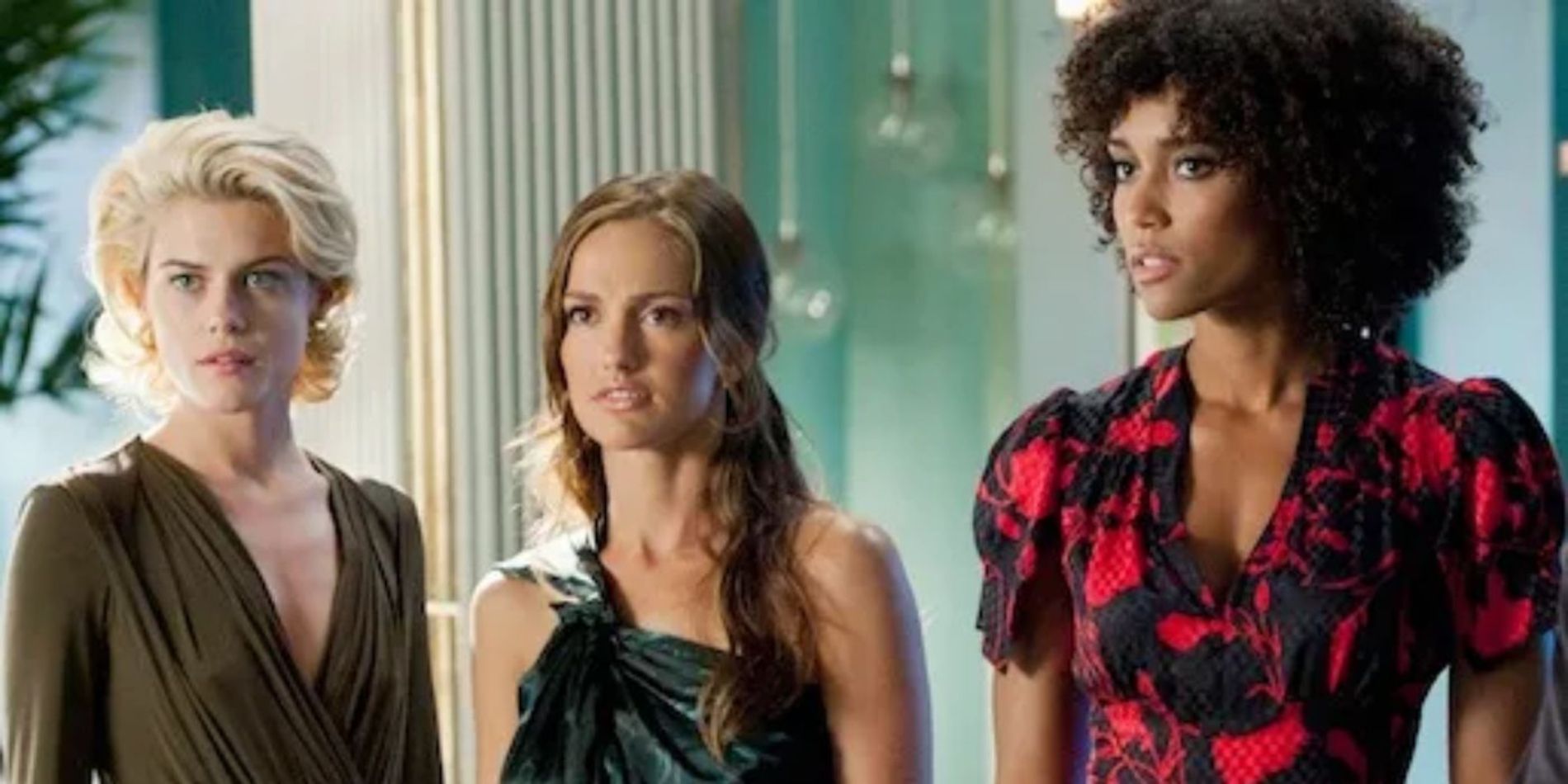 Three women in nice clothes stand next to each other and look at something off-camera in Charlie&rsquo;s Angels.