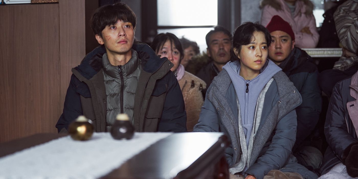 Park Seo-joon sitting next to Myeong-hwa Park Bo-young in Concrete Utopia