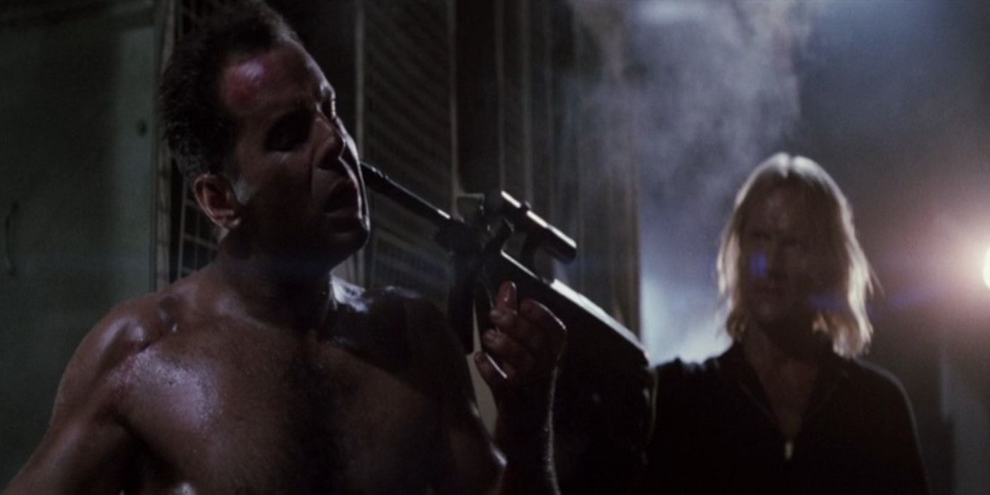 Karl points a gun directly at John McClane's face in Die Hard