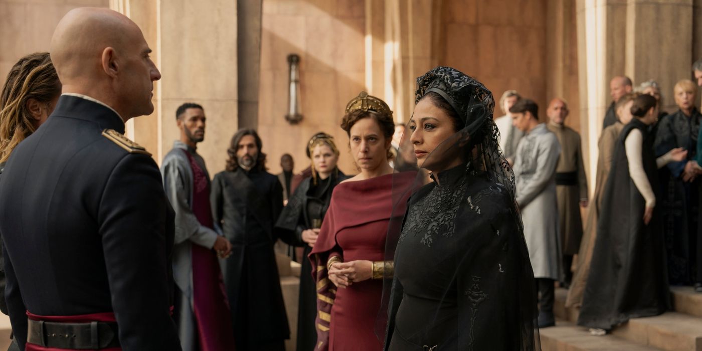 Mark Strong and Tabu looking at each other while Jodhi May watches on