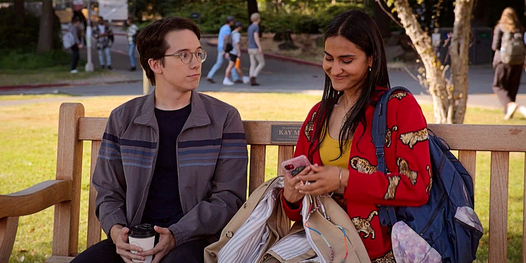 Eric and Bela sitting on a bench together in The Sex Lives of College Girls Season 2