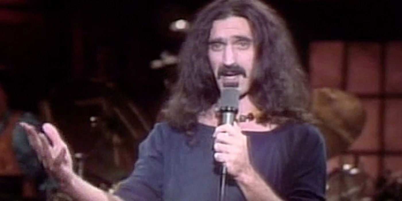 Frank Zappa talks into a mic on Saturday Night Live