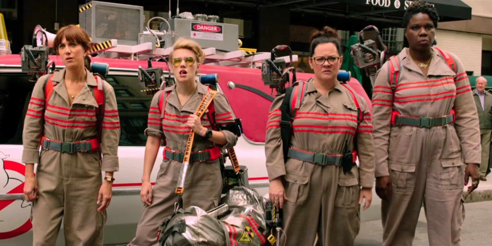 The Ghostbusters stand in front of Ecto-1 in 2016's 'Ghostbusters'.