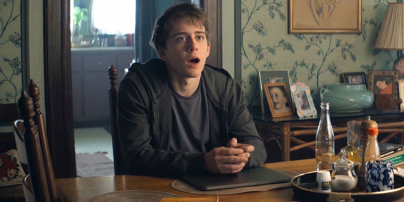 Devin (Sam McCarthy) sitting at a dining room table and looking offscreen toward the right in Goosebumps: The Vanishing