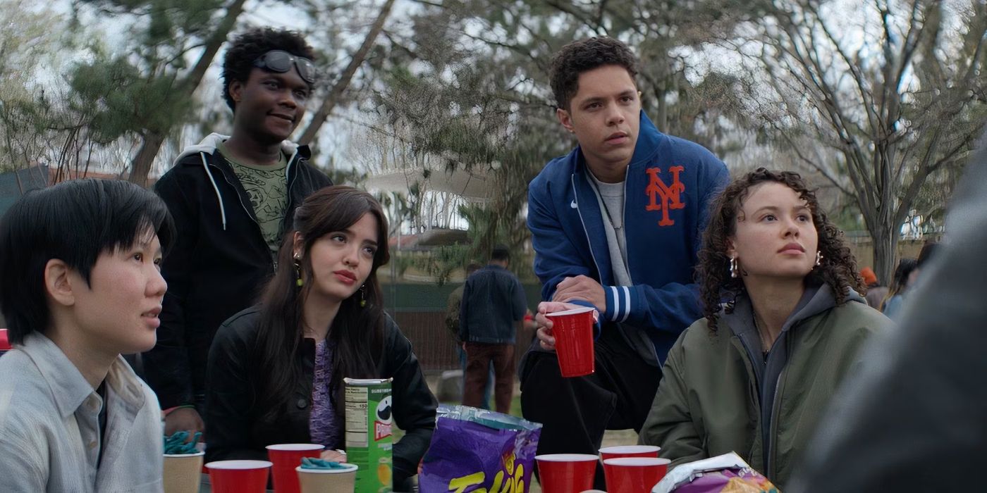 The teen cast of Goosebumps: The Vanishing sit and stand around an outside table filed with red plastic cups and potato chip bags