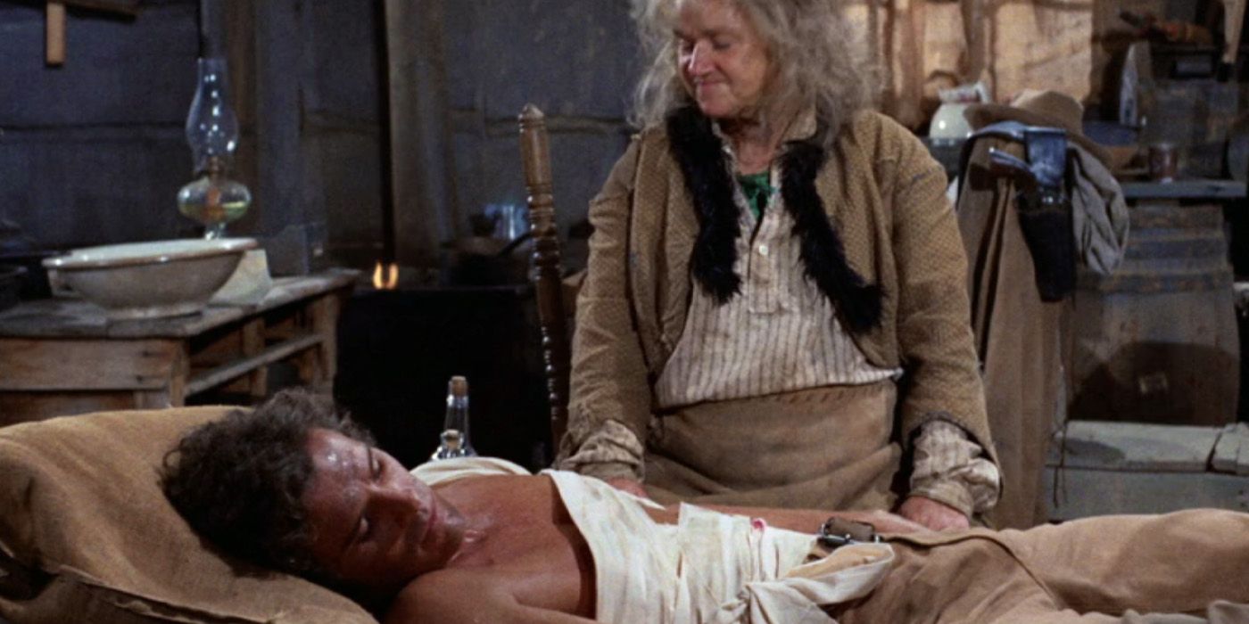 &lsquo;Dirty&rsquo; Sally Fergus (Jeanette Nolan) cares for an injured Cyrus Pike (Dack Rambo) in the &lsquo;Gunsmoke&rsquo; episode &ldquo;Pike&rdquo;