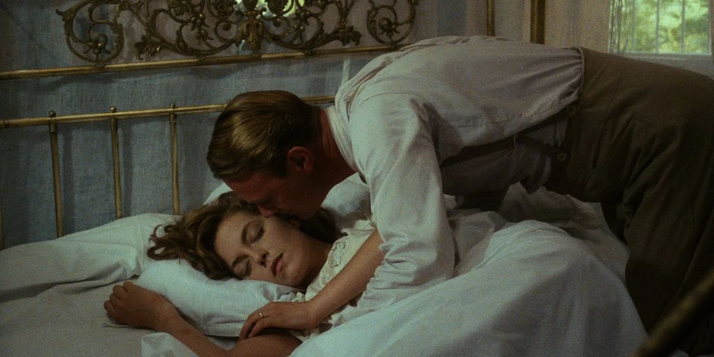 A man leans over to softly kiss a woman who is sleeping in Heat and Dust.