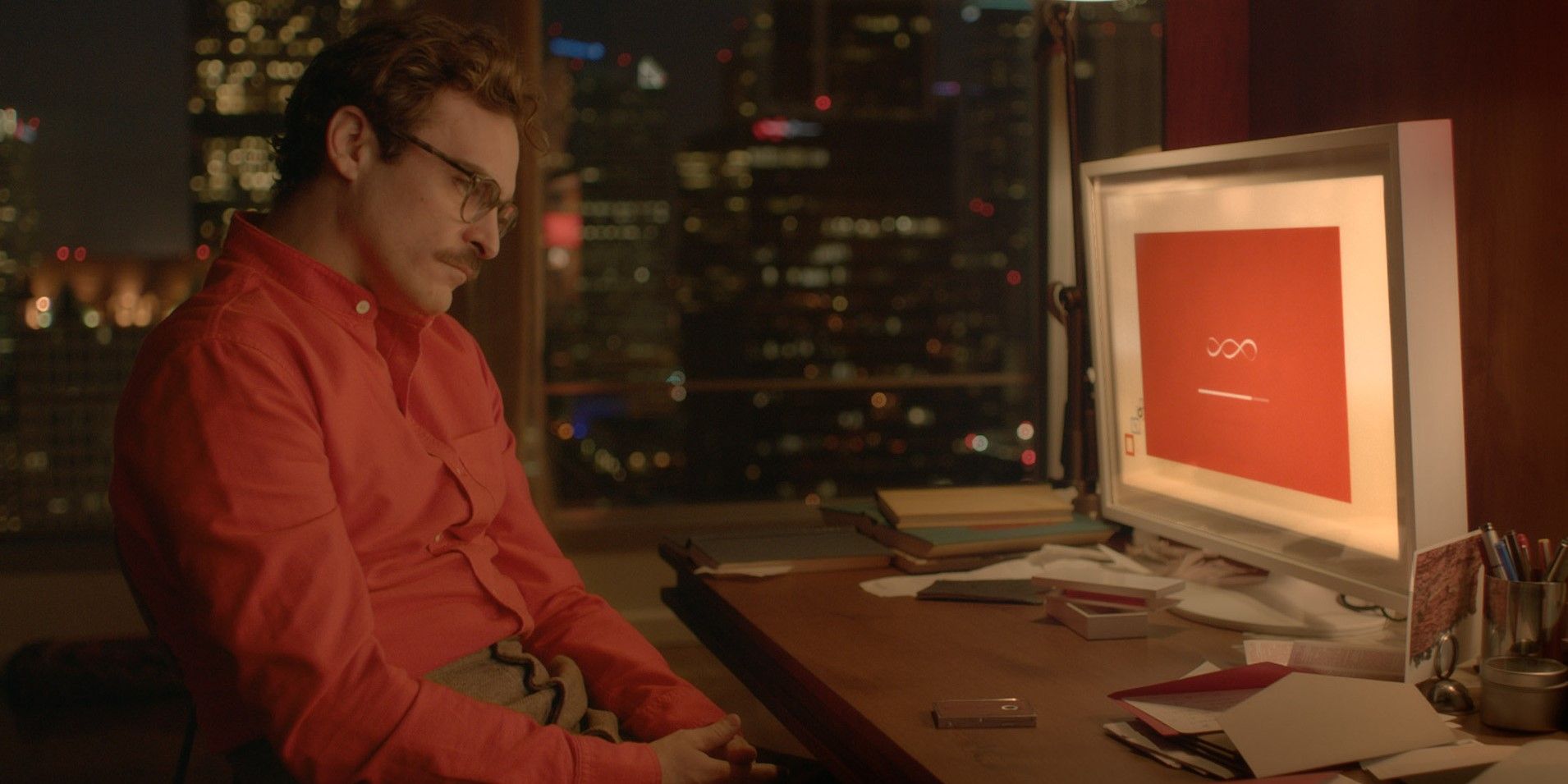 Joaquin Phoenix as Theo in Her sitting in front of his desktop