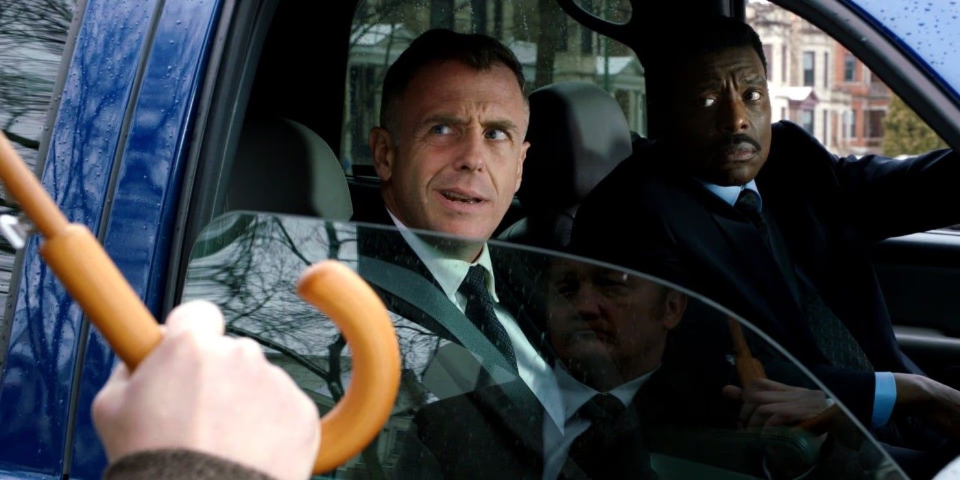 Herrmann (David Eigenberg) and Chief Boden (Eamonn Walker) in a car talking to someone on the sidewalk in the 'Chicago Fire' episode "A Coffin That Small"